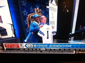 UConn's Byron Jones holds up his Dallas Cowboys jersey at the NFL Draft Thursday night (Ken Davis photo)