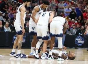 Justin Moore's Villanova teammates gathered around him when he was injured. (CHARLES FOX/Philadelphia Inquirer photographer)